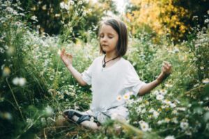 child in grass in a children's mental health treatment program