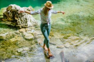 woman walking in river thinking about psychological assessments