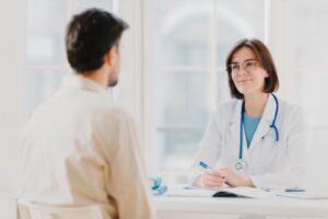 doctor discusses professional referrals with client