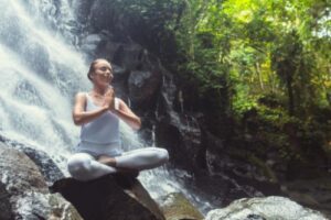 woman sitting by waterfall going through schizophrenia and psychotic disorders treatment programs