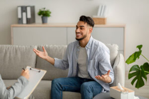 man talks in therapy about is mental health counseling stressful