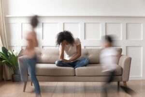 person sitting on couch while the world goes by wonders what is complex trauma