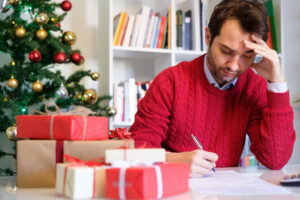 man signing cards considers anxiety and the holidays