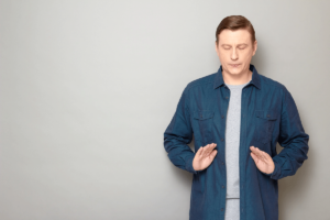 man does a breathing exercise while coping with anxiety