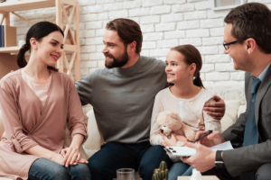 family smiles outdoors in family counseling