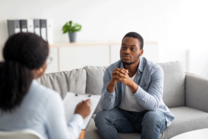 man sits on couch and talks about finding a psychiatrist in Bowie, MD