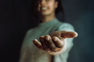 person holding out their hand on self-injury/harm awareness day