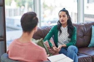 A woman is receiving mental health therapy