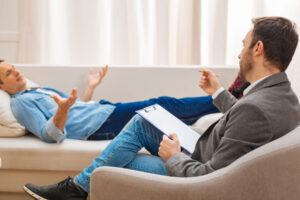 a patient lies down on a couch during their mental health counseling in woodridge