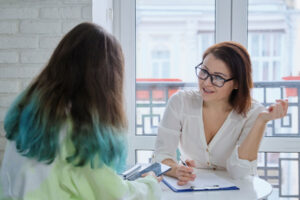 a person sits at a table and talks to a anxiety therapist at a towson md clinic location