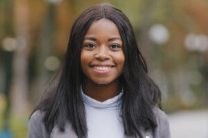A woman is facing the camera while smiling. She now knows fact vs fiction about common mental health myths and is getting the support she needs.