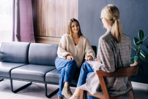 women speaking to therapist about medication