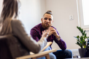 Man in plaid shirt in a therapy session for anxiety
